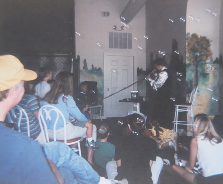 John performing at a birthday party